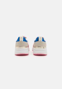 White, blue, and pink sneakers with grey and metallic accents; round toe, cushioned sole, and contrasting colored heel and tongue.