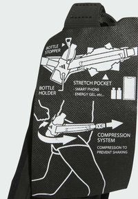 Black fabric accessory featuring diagrams of a bottle holder, bottle stopper, stretch pocket, and compression system for stability during use.