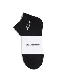 Juodas kulkšninis kamšilkas, pagamintas iš lygaus audinio, su balta išsiuvinėta emblemą. Supakuotas su baltu etikete, kurioje užrašyta "KARL LAGERFELD."