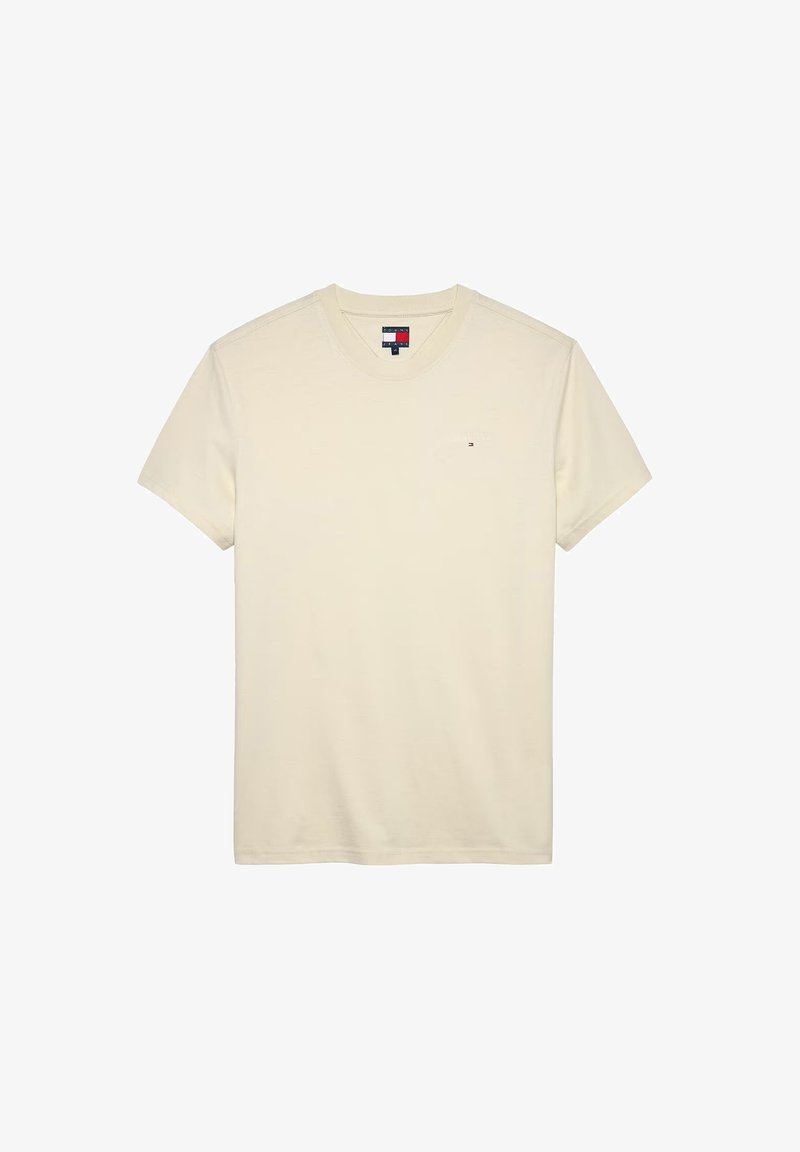 Camiseta de manga corta color crema, hecha de algodón, con cuello redondo y un pequeño logo en el pecho.