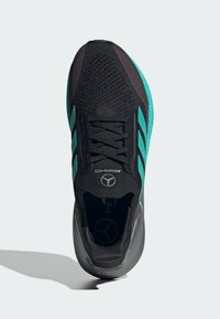 Black athletic shoe with turquoise accents, textured mesh upper, contrasting sole, and logo detail on the tongue. Lace-up design.