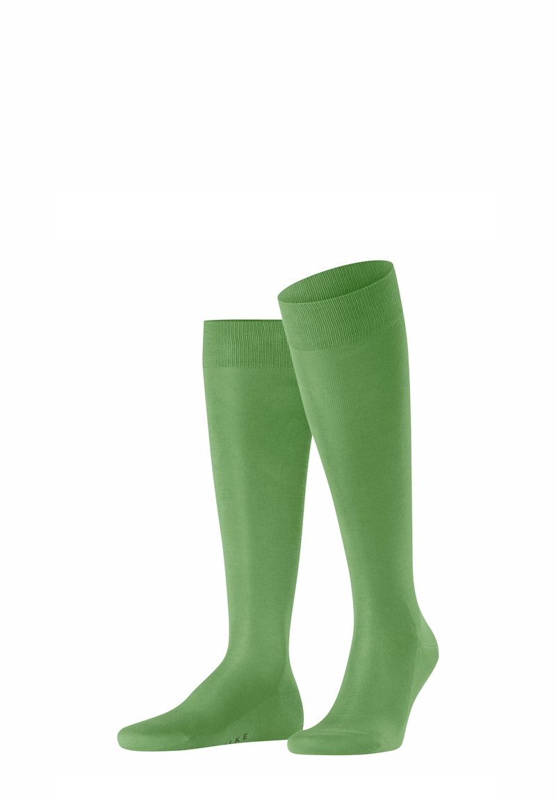 Calze al ginocchio di un brillante colore verde, realizzate in materiale morbido ed elastico con una texture liscia e polsini a costine.
