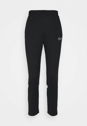 Pantalones deportivos negros con cintura elástica, corte slim, piernas ajustadas y un acento del logo de Nike en blanco en la parte superior izquierda.