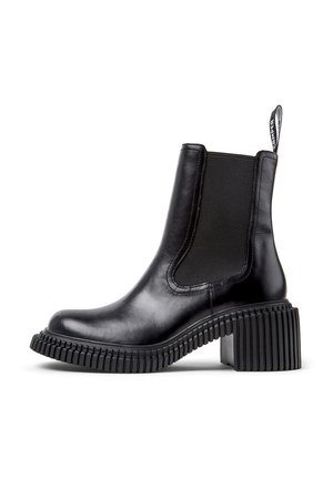 Black leather ankle boot with elastic side panels, round toe, textured rubber sole, and a ribbed chunky heel. Features a pull tab.
