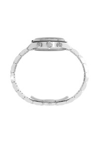 Sudraba metāla pulkstenis ar apaļu korpusu, teksturētu ciparnīcu un trim pogām. Siksna sastāv no savienotiem, ovāla formāta metāla segmentiem, kas nodrošina elastību.