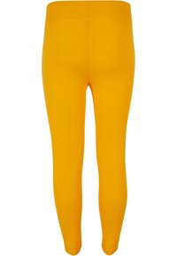 Gule leggings laget av elastisk materiale, med en glatt tekstur og en tettsittende design, med et enkelt, ensfarget mønster.