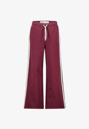 Pantaloni da jogging larghi in cotone color bordeaux, con strisce laterali bianche e una vita elastica con coulisse. Tessuto morbido.