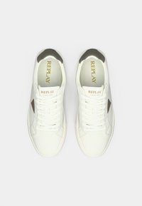 Pair of white Replay sneakers with laces, black heel accents, and Replay logo on tongue and insoles, shown from top view.