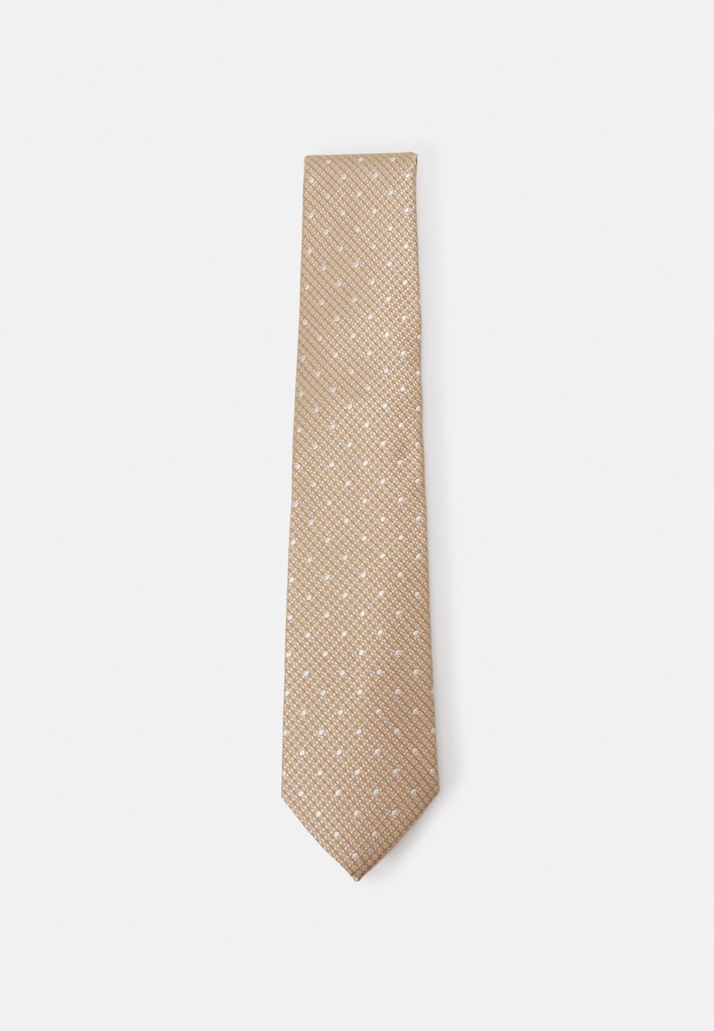 Cravate beige avec un motif texturé et de petits points blancs, de forme étroite et à extrémité pointue. Fini lisse avec un léger éclat.
