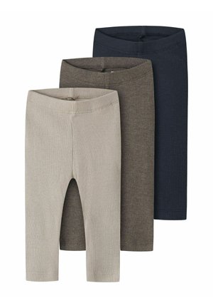 Trois paires de leggings en maille côtelée beige, marron et bleu marine, empilées verticalement avec les ceintures élastiques visibles.