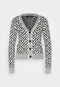 Zwart-wit gebreid vest met een geometrisch patroon, V-hals, lange mouwen en vijf zwarte knopen aan de voorkant.