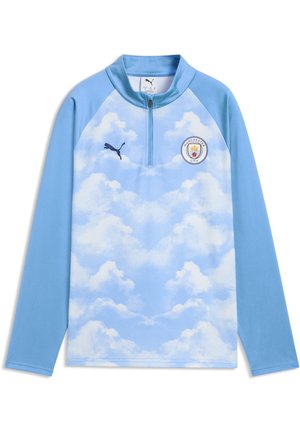 Top sportivo a maniche lunghe azzurro chiaro con motivo a nuvola bianca, mezza cerniera, logo Puma sul lato destro del petto e stemma del club di calcio Manchester City sul lato sinistro del petto.