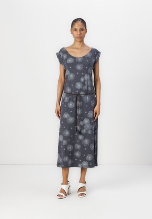 Gray floral dress made from soft fabric, featuring short sleeves, a drawstring waist, and a flowing silhouette. Paired with white sandals.