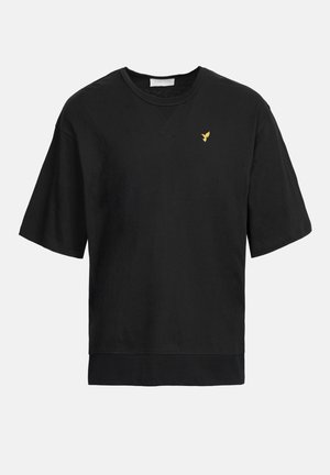 Sort bomulds t-shirt med korte ærmer og rund halsudskæring. Har et diskret guld fugle emblemen på brystet. Glat tekstur, afslappet pasform.