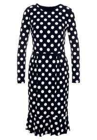 Långärmad, svart klänning med vita prickar och utsvängd nederkant. Tillverkad av ett mjukt, elastiskt material med rund halsringning och figurnära midja.