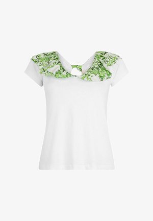 T-shirt bianca a maniche corte, con un collettino a balze con motivo floreale verde e un dettaglio a occhio sul retro. Materiale in cotone morbido.