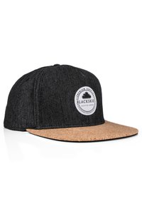 Black denim cap with cork brim, featuring a round logo patch labeled "BLACKSKIES" and contrasting stitching.