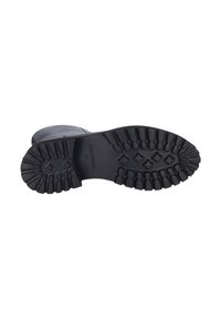Black rubber boot sole with deep treads, featuring a textured surface and raised patterns for grip. Branding visible at the heel.
