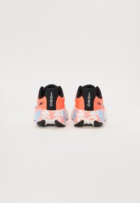 Sport shoes with a pink and orange fabric upper, black accents, and a patterned white sole featuring blue and pink designs.