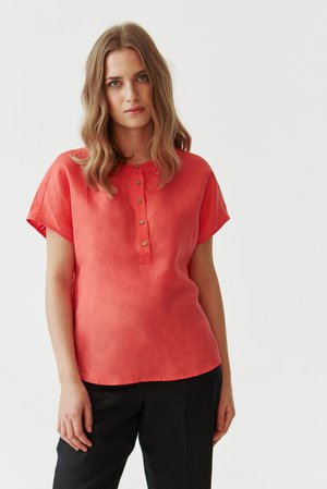 Coral linen blouse with short, rolled sleeves, a buttoned placket, and a relaxed fit. Smooth texture with subtle sheen.