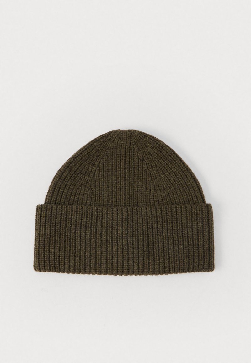 Ribbed knit beanie in olive green, featuring a folded cuff and soft texture. Design offers a snug fit with a rounded top.
