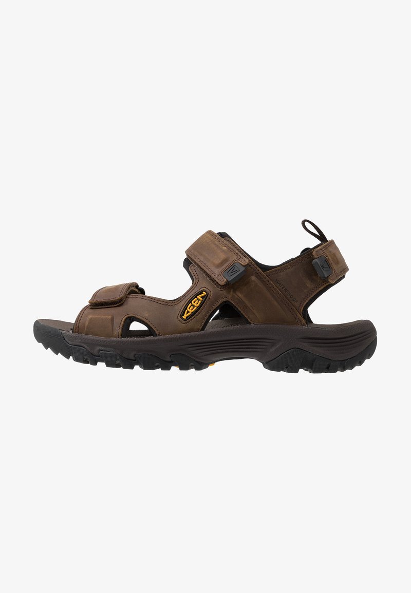 Brown waterproof sandal with adjustable Velcro straps, open design, rugged black outsole, and notable Keen logo on the side.