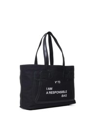 Sac en toile noir avec deux anses noires. Présente un texte blanc "JE SUIS UN SAC RESPONSABLE" et un design de poche cousue.