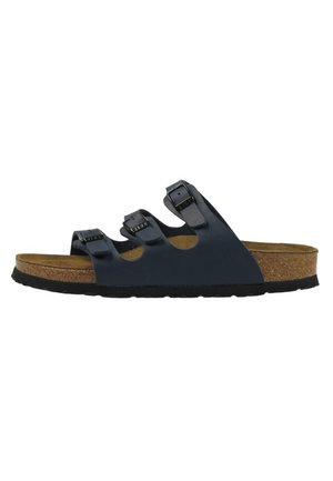 Black sandal with three adjustable straps, cork footbed, textured rubber sole, and slight arch support. Side view showcasing design details.