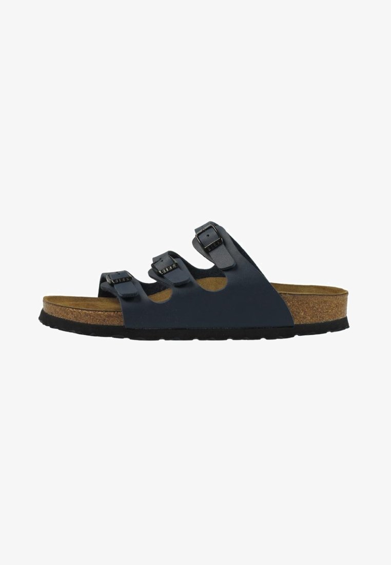 Black sandal with three adjustable straps, cork footbed, textured rubber sole, and slight arch support. Side view showcasing design details.