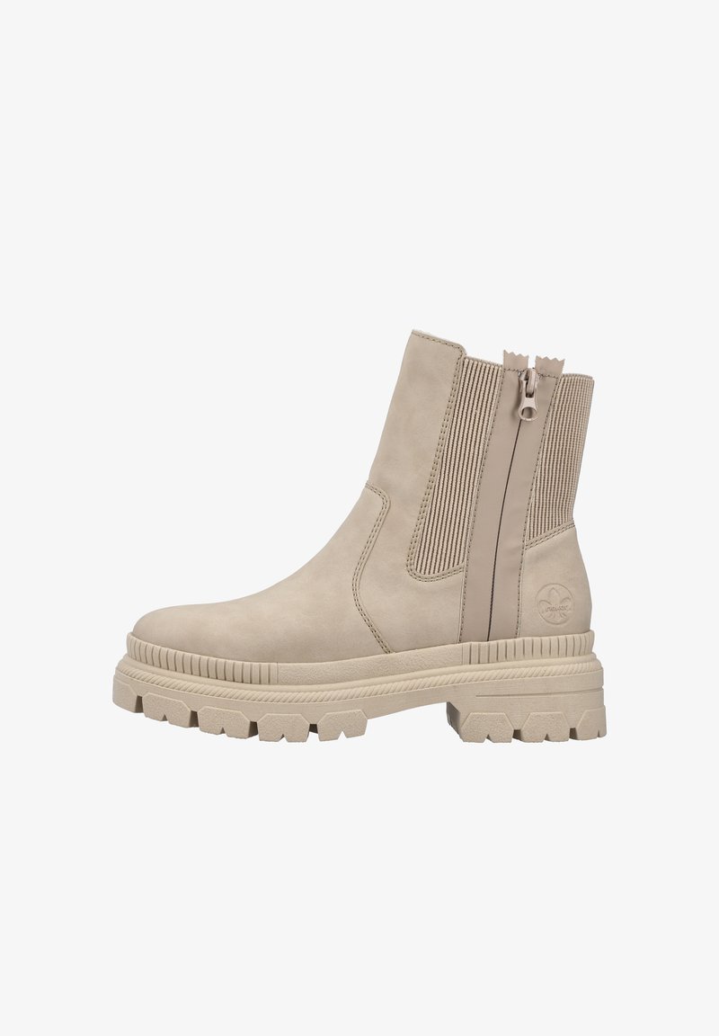 Bottine beige à semelle épaisse, fermeture éclair latérale, panneau élastique, bout rond et logo de la marque embossé près du talon.