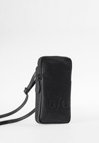 Black rectangular crossbody bag made of textured material, featuring a zip closure and embossed logo on the front. Adjustable strap included.