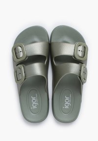 Green synthetic slide sandals with two adjustable buckles, textured straps, and a textured footbed. Brand logo visible on the side.