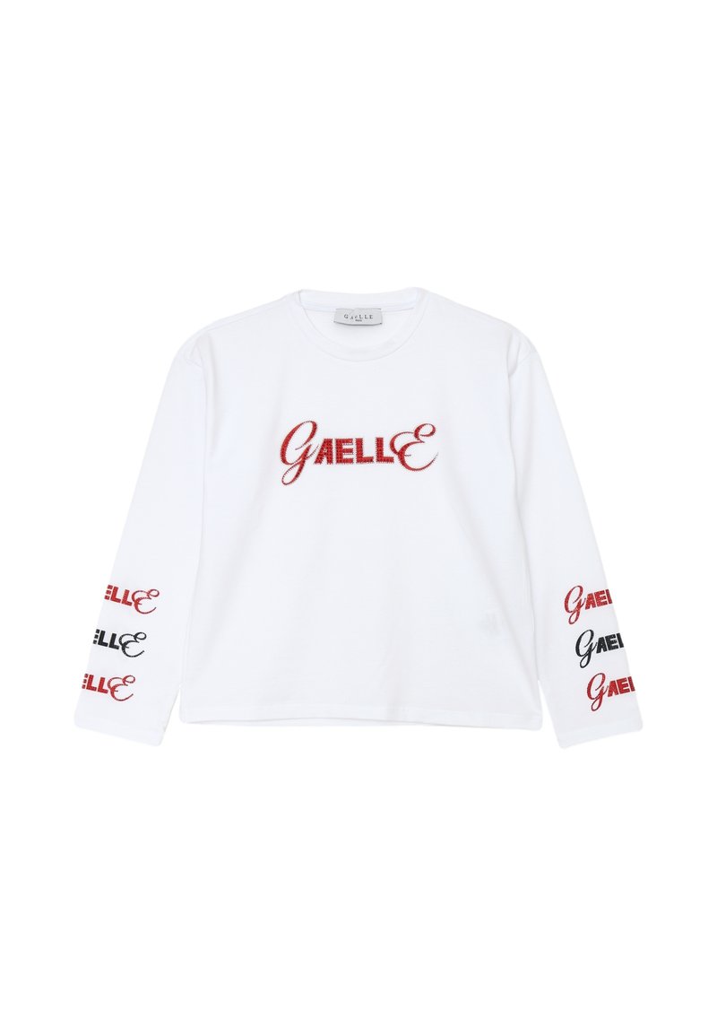 Camicia bianca a maniche lunghe con ricamo rosso "GAELLE" sul davanti e dettagli in nero e rosso sulle maniche. Materiale in cotone.