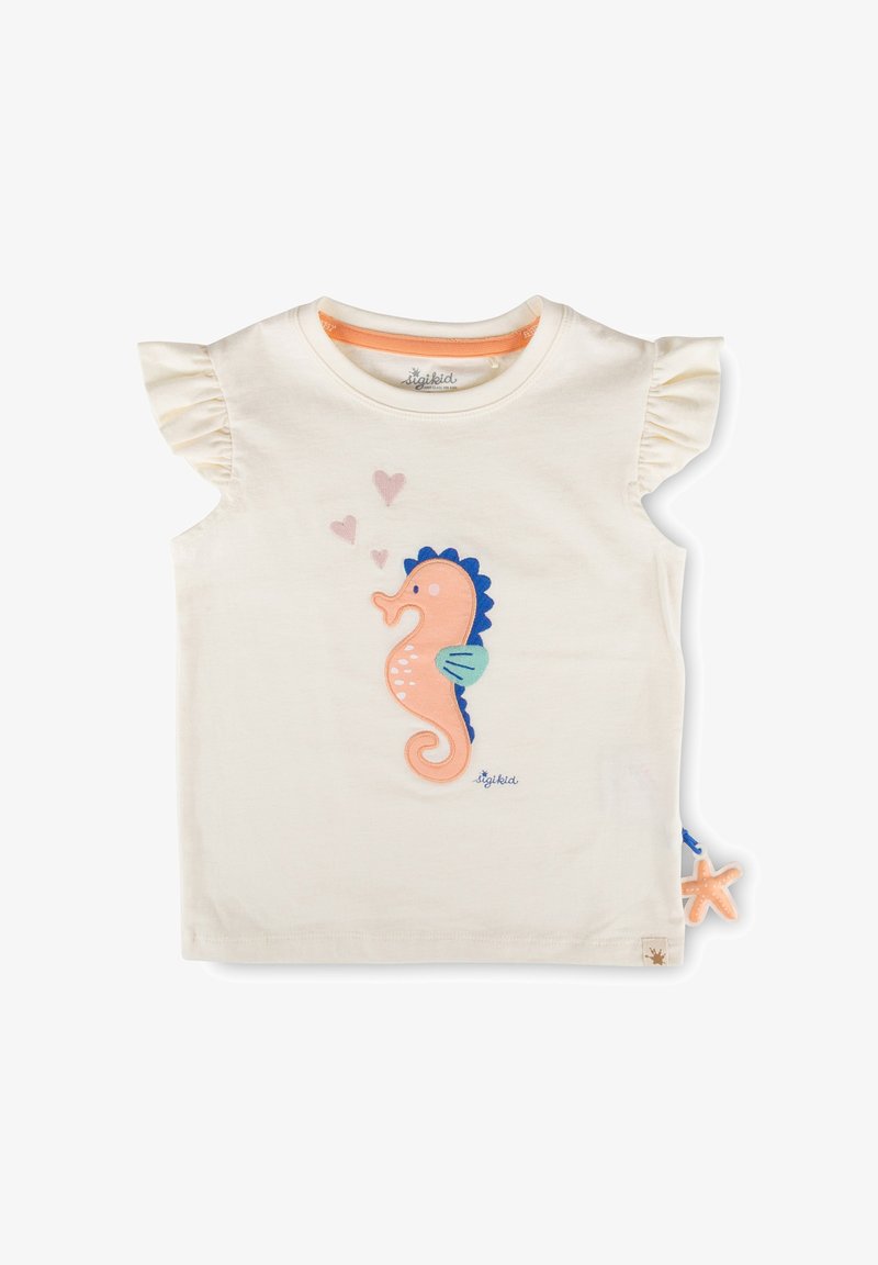 T-shirt crème pour tout-petit à manches volantées, avec un appliqué hippocampe rose et bleu au centre et trois petits cœurs roses.