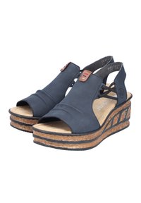 Black wedge sandals with an open toe, elastic straps, and a cork-textured platform. Features subtle brown leather accents and textured insole.