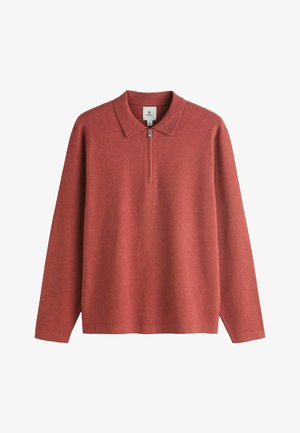 Polo a maniche lunghe di colore rosso smorzato con colletto con zip. Realizzato in tessuto morbido dalla texture liscia e design minimalista.