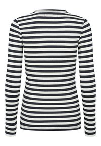 Langermet skjorte med ribbet tekstur, med horisontale svart-hvite striper. Rund hals og tettsittende design.