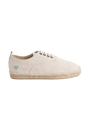 Zapato de lona beige claro con punta redondeada, suela de yute tipo espadrille, sistema de cordones con cinco ojetes y un sutil emblema azul en el costado.