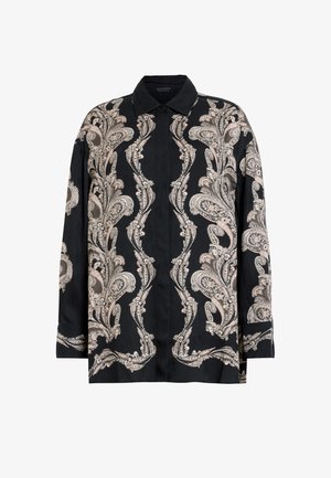 Mustasärk terava kraega, millel on keerukad beežid paisleimustrid ja sile tekstuur. Pikad varrukad, nööbid ees.