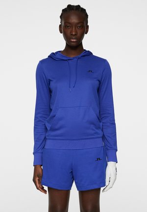 Felpa con cappuccio blu dotata di tasca frontale, abbinata a pantaloni corti blu. Presenta un logo nero sul petto e sui pantaloni corti. Tessuto morbido.
