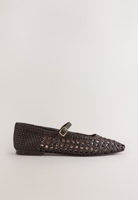 Dark brown woven leather flat shoe with pointed toe and adjustable strap with small gold buckle against a plain background.