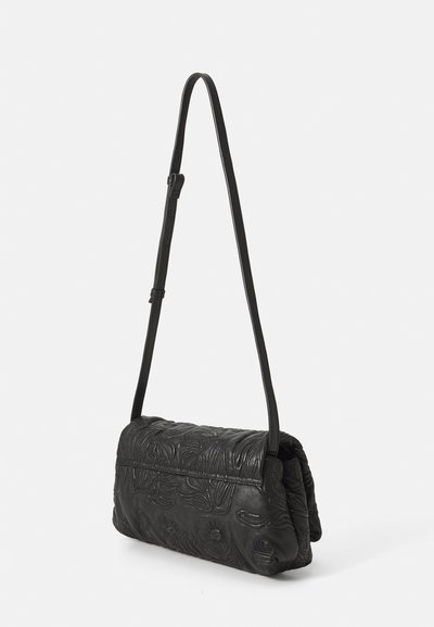 Black leather shoulder bag with embossed floral patterns, a structured shape, a single adjustable strap, and a fold-over flap closure.