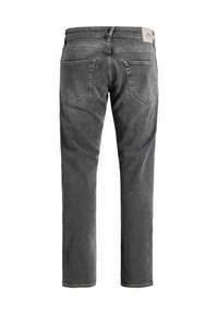 Dunkelgraue Denim-Jeans von hinten gezeigt, mit zwei hinteren Taschen und einem hellbeigen Etikett am Bund.