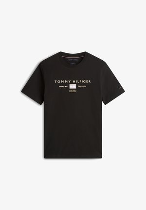 T-shirt noir à manches courtes avec le texte "Tommy Hilfiger American Classics EST. 1985" et le logo sur la poitrine, petit logo drapeau sur la manche gauche.
