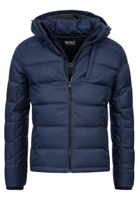 Marineblå pufferjakke med lynlås foran, aftagelig hætte, struktureret stof og quiltet design. Har sidelommer og et mærketikette indeni.