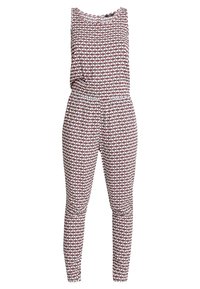 Ärmlös jumpsuit i ett rödvitt geometriskt mönster. Har en figursydd midja och smalnande ben, tillverkad av ett lätt tyg.