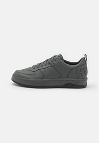 Gray leather sneaker with a textured finish, featuring a padded collar, lace-up design, and contrasting black rubber sole with logo detail.