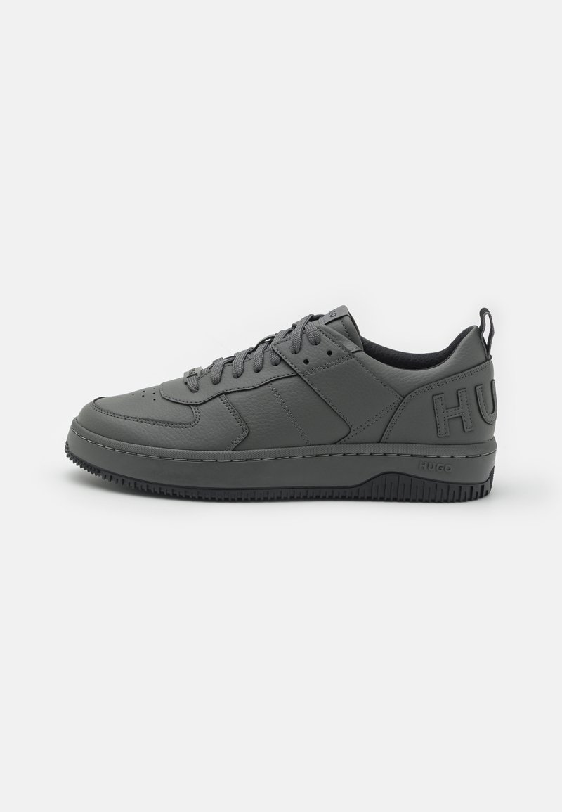 Gray leather sneaker with a textured finish, featuring a padded collar, lace-up design, and contrasting black rubber sole with logo detail.