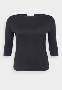 Musta, pitkähihainen paita, jossa on leveä pääntie, valmistettu sileästä kankaasta. Rinnassa on pieni, huomaamaton logo. Yksinkertainen muotoilu.