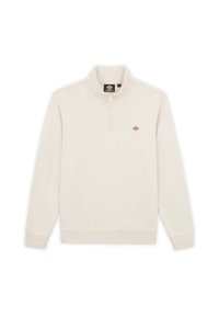 Felpa beige chiara con colletto a zip corta, maniche lunghe e un piccolo logo sul petto. Tessuto morbido con una consistenza liscia.